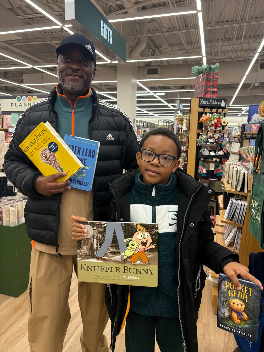 Melvin with a young reader choosing books, November 2025