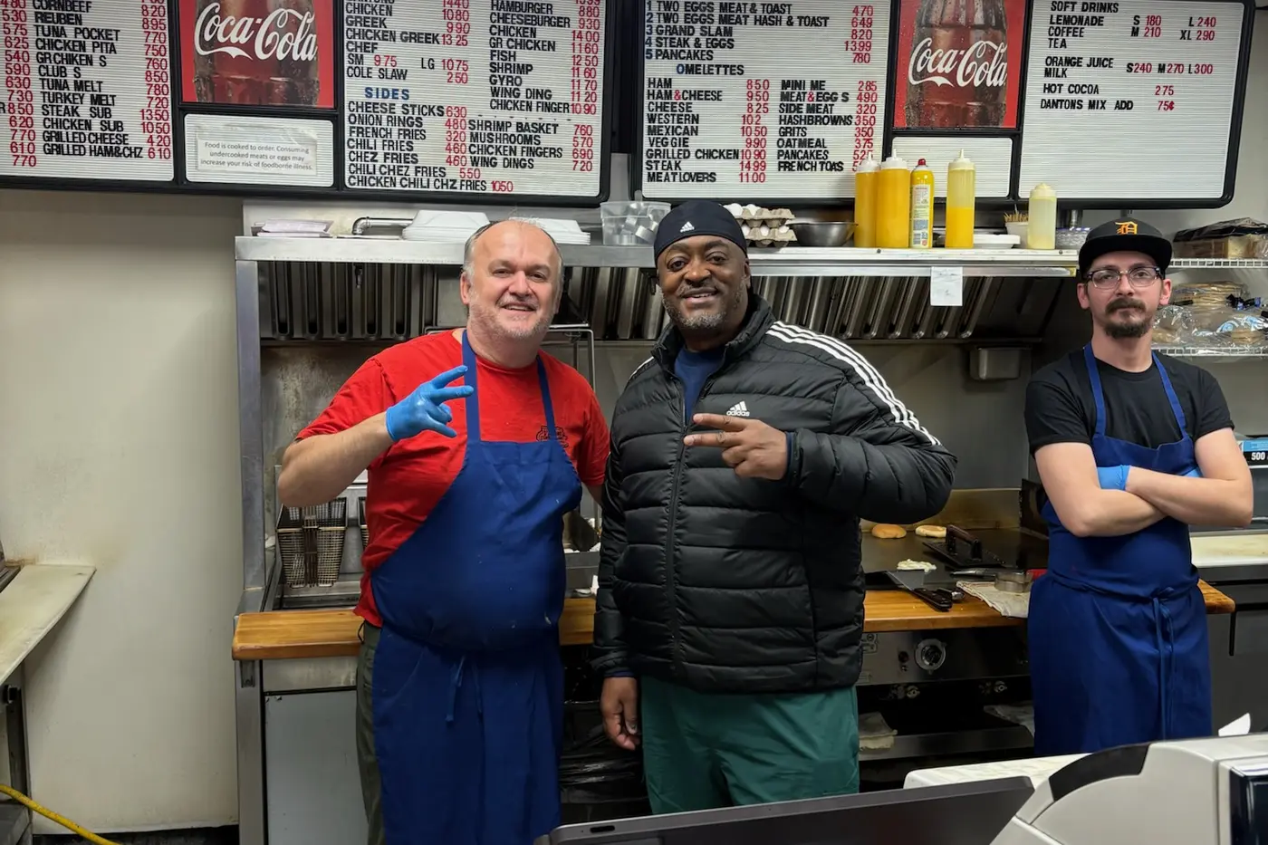 Melvin with the crew behind the counter of a Pontiac diner, February 2025